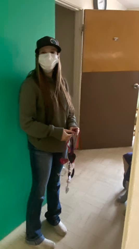 Student holding a door hanger