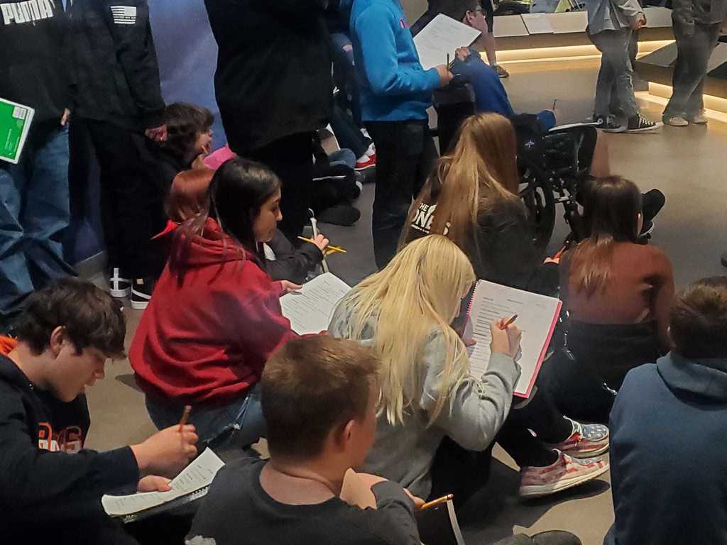Students writing notes